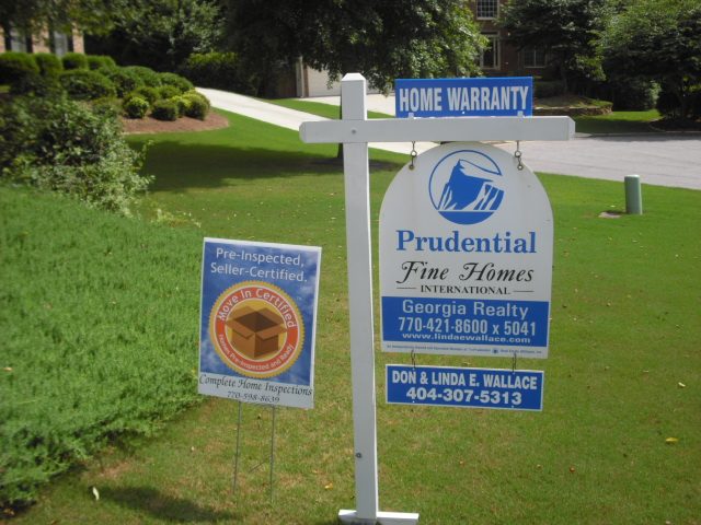 Pre-inspected sign in front of a home for sale